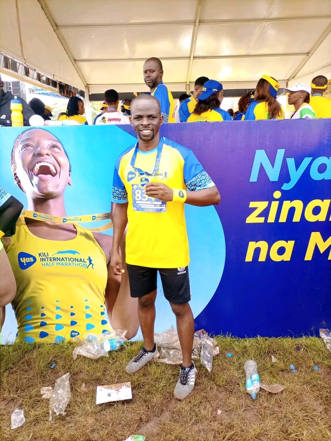 Runner posing at the Kili International Half Marathon branding