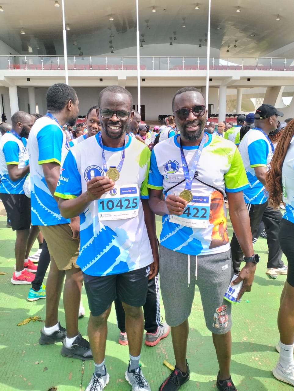 Half marathon finishers displaying their gold medals