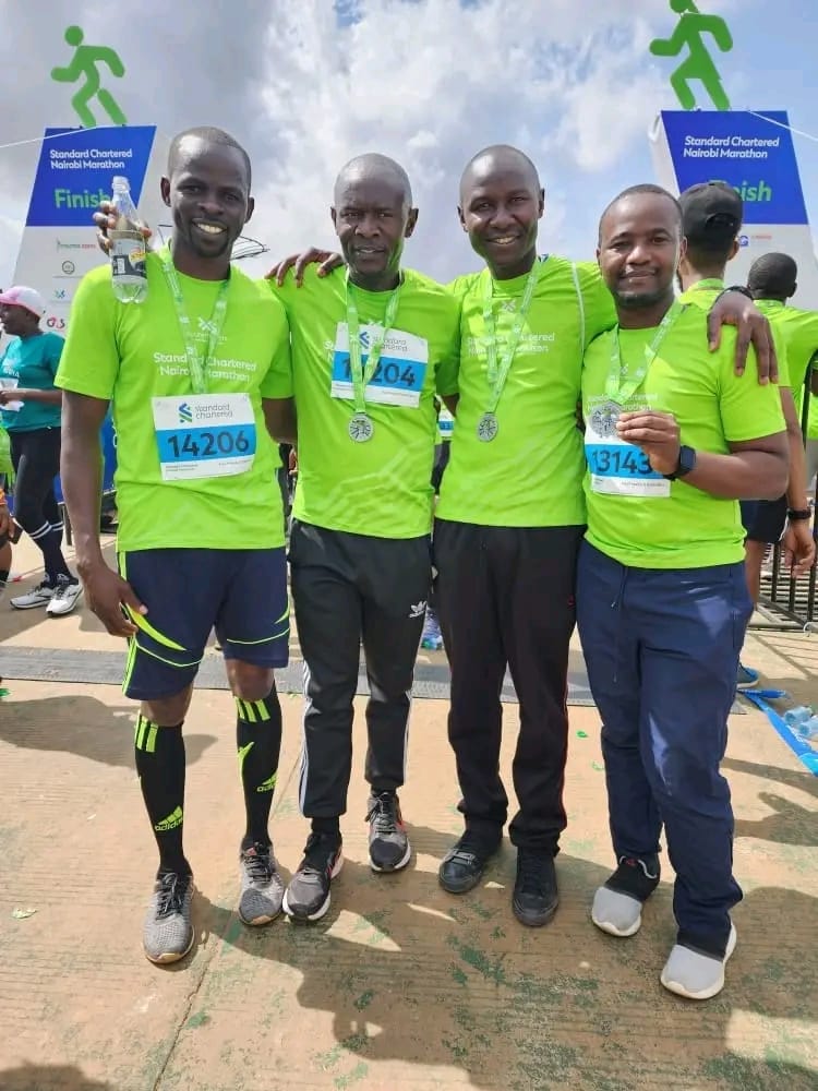 Four finishers with medals at the Nairobi Marathon
